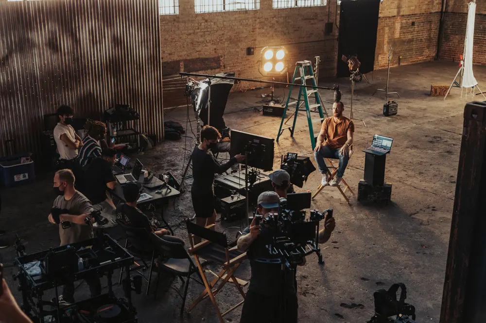 Film crew shooting on a lit set
